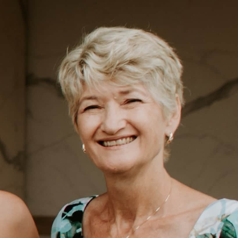 Senior woman smiling outdoors, happy and relaxed.